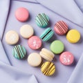 Smooth, glossy texture of the macarons contrasts with the fabr Royalty Free Stock Photo