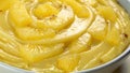 Flat Lay of Yellow Pineapple Sauce with Swirling Texture and Glossy Surface Across the Entire Frame Royalty Free Stock Photo