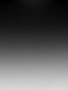 A smooth gradient background transitioning from dark black at the to light grey at the bottom creating a subtle and minimalist Royalty Free Stock Photo