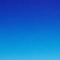 A smooth gradient sky with rich blue hues transitioning from lighter at the bottom to Royalty Free Stock Photo