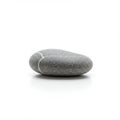 Smooth gray pebble on a white background. Oval-shaped, it features a fine-grained Royalty Free Stock Photo