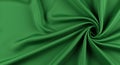 Smooth green fabric with a swirling pattern, creating a dynamic, spiral effect. The
