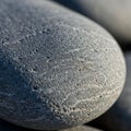 Smooth grey stone with a round shape and fine texture, showing Royalty Free Stock Photo