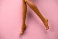 smooth legs of a plastic toy doll on a soft pink background Royalty Free Stock Photo