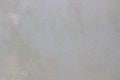 A smooth light gray surface featuring subtle speckles and faint stains, creating a clean and neutral background or texture Royalty Free Stock Photo