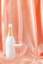 Smooth luxury design made with silk or satin curtain, champagne bottle and crystal glass filled with white pearls.