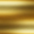 A smooth metallic gold texture with a gradient effect. The surface appears polished, reflecting Royalty Free Stock Photo