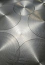 Smooth metallic surface with overlapping circular patterns, creating a textured Royalty Free Stock Photo