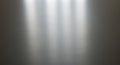 A smooth metallic surface with a reflective sheen displays soft light reflections, Royalty Free Stock Photo