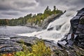 Smooth milky white waterfall on dark-colored rocks - side view - long exposure