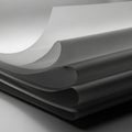 Smooth, monochromatic sheets of paper are stacked in a layered arrangement, creating a gentle Royalty Free Stock Photo