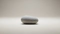 Smooth, oval-shaped gray stone resting on a light surface. The stone s texture Royalty Free Stock Photo