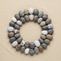 Smooth pebbles are arranged in a circular pattern on sandy ground Royalty Free Stock Photo