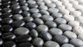 Of smooth pebbles arranged in a gradient pattern from black to Royalty Free Stock Photo