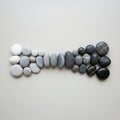 Smooth pebbles arranged in a gradient sequence from light to dark tones Royalty Free Stock Photo