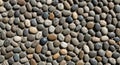 Smooth pebbles closely packed together create a textured surface. The stones vary in Royalty Free Stock Photo