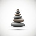 Smooth pebbles are stacked in a balanced formation against a plain white Royalty Free Stock Photo