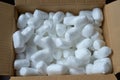 Smooth pieces of styrofoam in brown open postal parcel. It is a reliable way to transport items for their safety