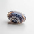 Smooth, polished agate stone with concentric bands of blue, white, and brown Royalty Free Stock Photo