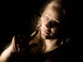 Smooth portrait of model, posing behind transparent glass covered by water drops. young melancholy and sad woman Royalty Free Stock Photo