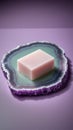 Pink soap bar on a purple agate slice against a lavender background bar soap cleansing Royalty Free Stock Photo