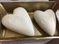 Smooth rock hearts on golden container