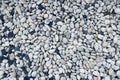 Smooth round pebbles texture background. Pebble sea beach close-up, dark wet pebble and gray dry pebble Royalty Free Stock Photo