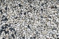Smooth round pebbles texture background. Pebble sea beach close-up, dark wet pebble and gray dry pebble Royalty Free Stock Photo