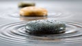 Smooth round stones floating on calm water creating serene ripple patterns with soft focus stones lined up in tranquil reflective Royalty Free Stock Photo