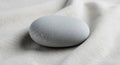 Smooth, rounded gray stone resting on Royalty Free Stock Photo