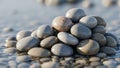 Smooth, rounded pebbles stacked in a small mound sit on a wet surface Royalty Free Stock Photo