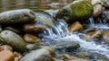 Smooth rounded stones creating gentle ripples and a small waterfall Royalty Free Stock Photo