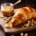 Smooth And Shiny Croissant With Peanut Butter And Nuts On Wood Royalty Free Stock Photo