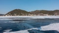 On the smooth surface of the frozen lake, patches of snow are visible.