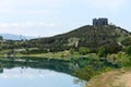 Smooth surface of Tbilisi reservoir water and hill with monument Chronicles of Georgia in morning