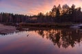 Smooth surface of the water in the river. Reflection in the water of trees, forest and sunset. Russia Royalty Free Stock Photo