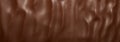 Chocolate photo background.Smooth texture of milk chocolate.