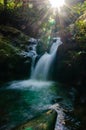 smooth waterfall emerald color with sunray