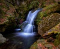 Smooth waterfall among rocks in autumn Royalty Free Stock Photo