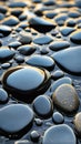 Smooth wet black pebbles with reflections of light. Zen, relaxation, and spa concept. Natural stone texture background Royalty Free Stock Photo