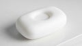 Bar of soap with an oval shape and a distinctive central indent resting Royalty Free Stock Photo