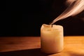 Smooth, white beautiful smoke from candle. Extinguished candle on wooden table Royalty Free Stock Photo