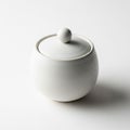 Smooth white ceramic jar with a matching lid featuring a spherical handle Royalty Free Stock Photo