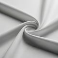Smooth, white fabric arranged in a swirling pattern, creating a central spiral. The texti Royalty Free Stock Photo