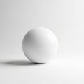 A smooth white sphere is centered against a neutral gray backdrop Royalty Free Stock Photo