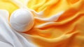 Smooth white sphere on vibrant orange-yellow fabric Royalty Free Stock Photo