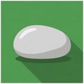 Of a smooth, white stone with a glossy surface against a solid green Royalty Free Stock Photo