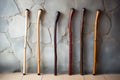 smooth wooden walking sticks leaning against a wall