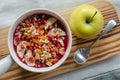 Smoothie acai bowl topped with pomegranate, bananas, flaxseeds, cedar seeds, dried apricot and granola. Acai breakfast superfoods