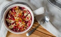 Smoothie acai bowl topped with pomegranate, bananas, flaxseeds, cedar seeds, dried apricot and granola. Acai breakfast superfoods